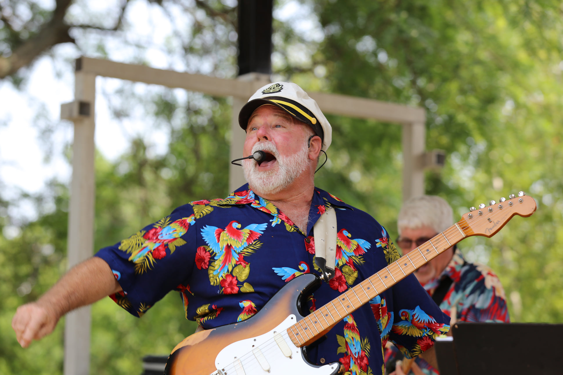 Bobby Way singing and playing guitar on stage